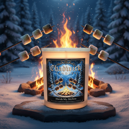 Candle with a winter scene design on a snowy landscape with a fire and marshmallows.