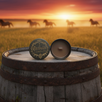 Two coins on a barrel with horses in the background at sunset.