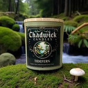 Chadwick Candles tin in a natural setting with greenery and water.